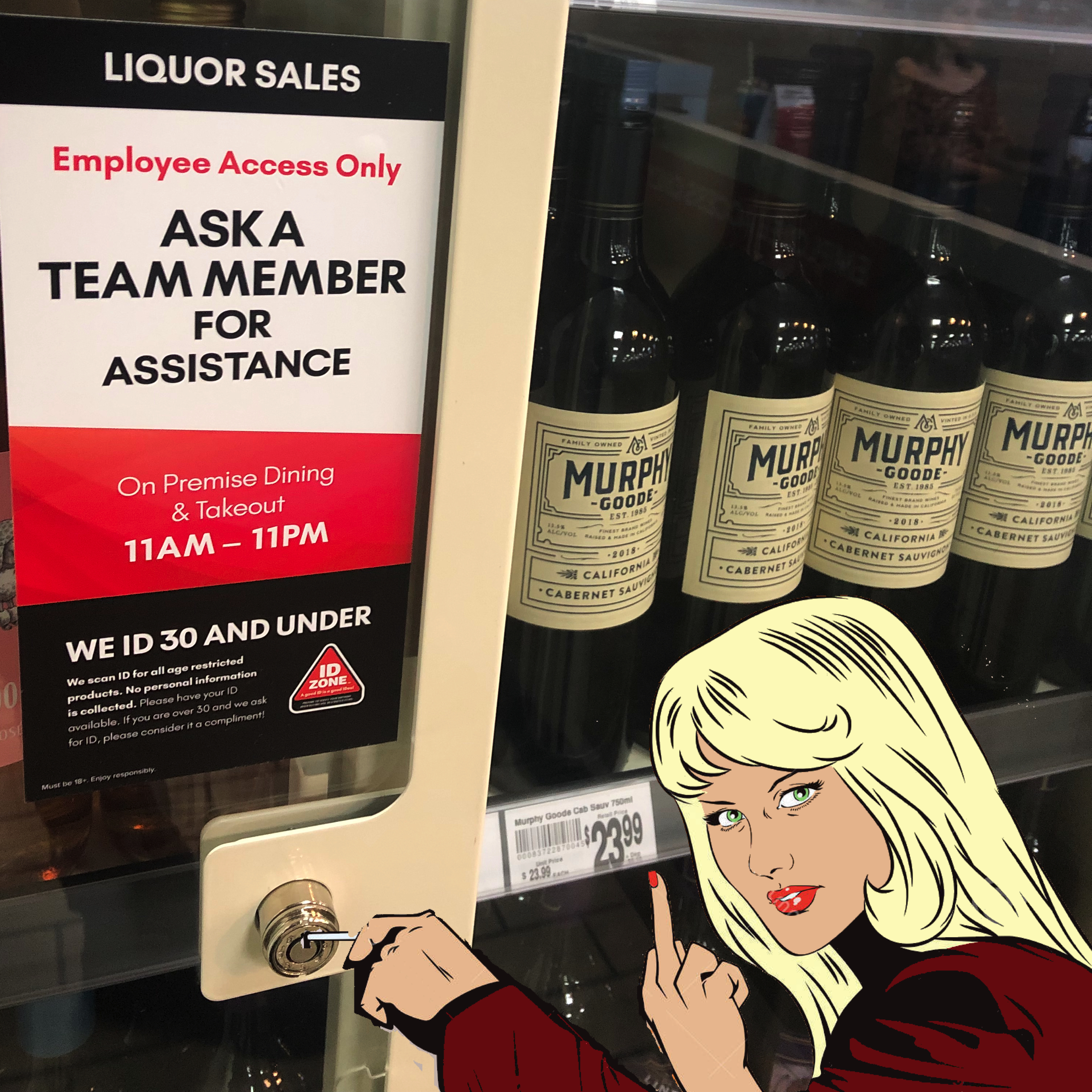 The alcohol refrigerator in the store. There is a woman sticking a pin into the lock. 