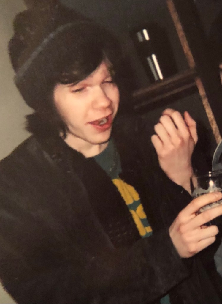 A photo of the author, circa 2006 or 2007, holding a beer and looking very intoxicated. 