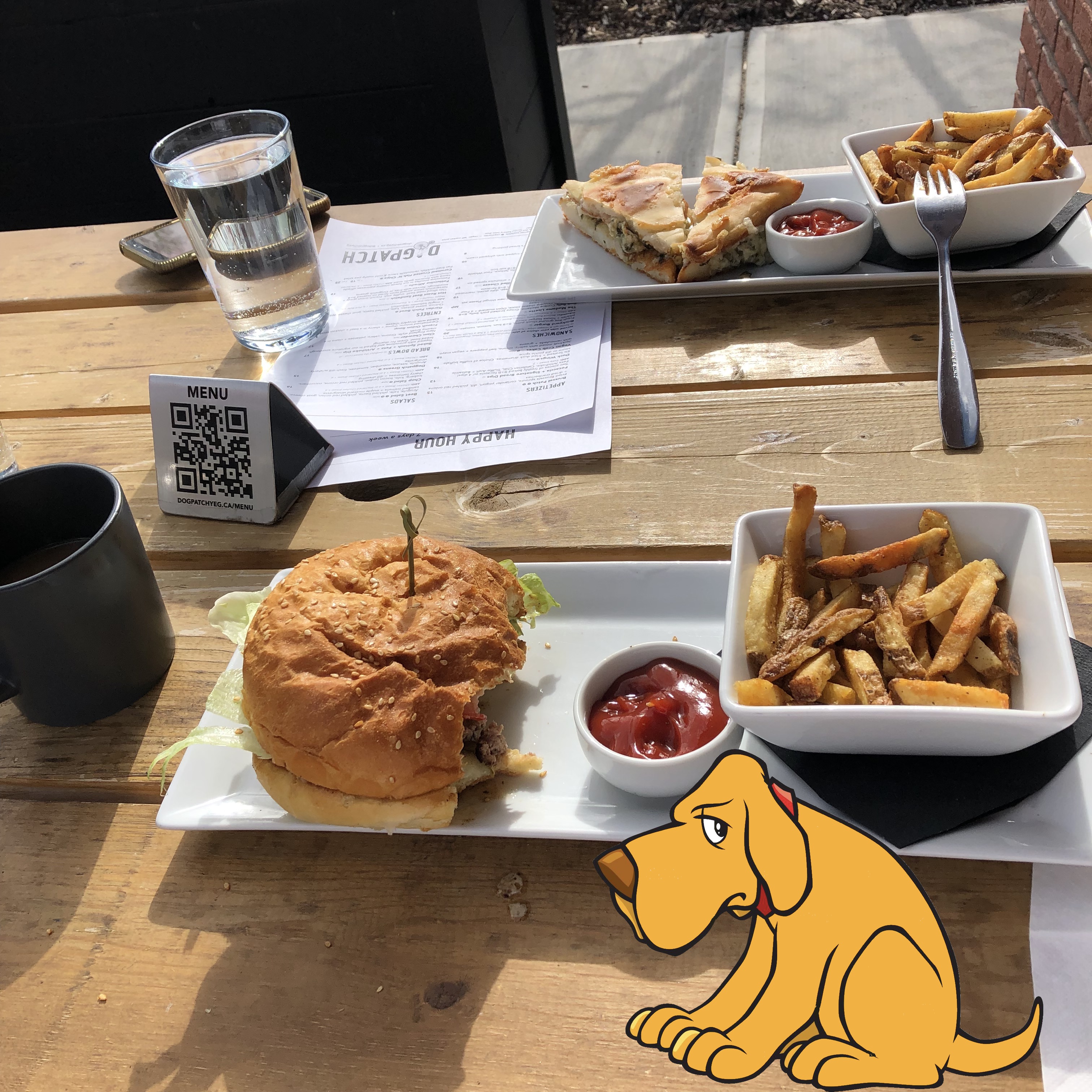 Hamburger with a few bites out of it, a shallow tray of fries, and a disappointed looking dog. 