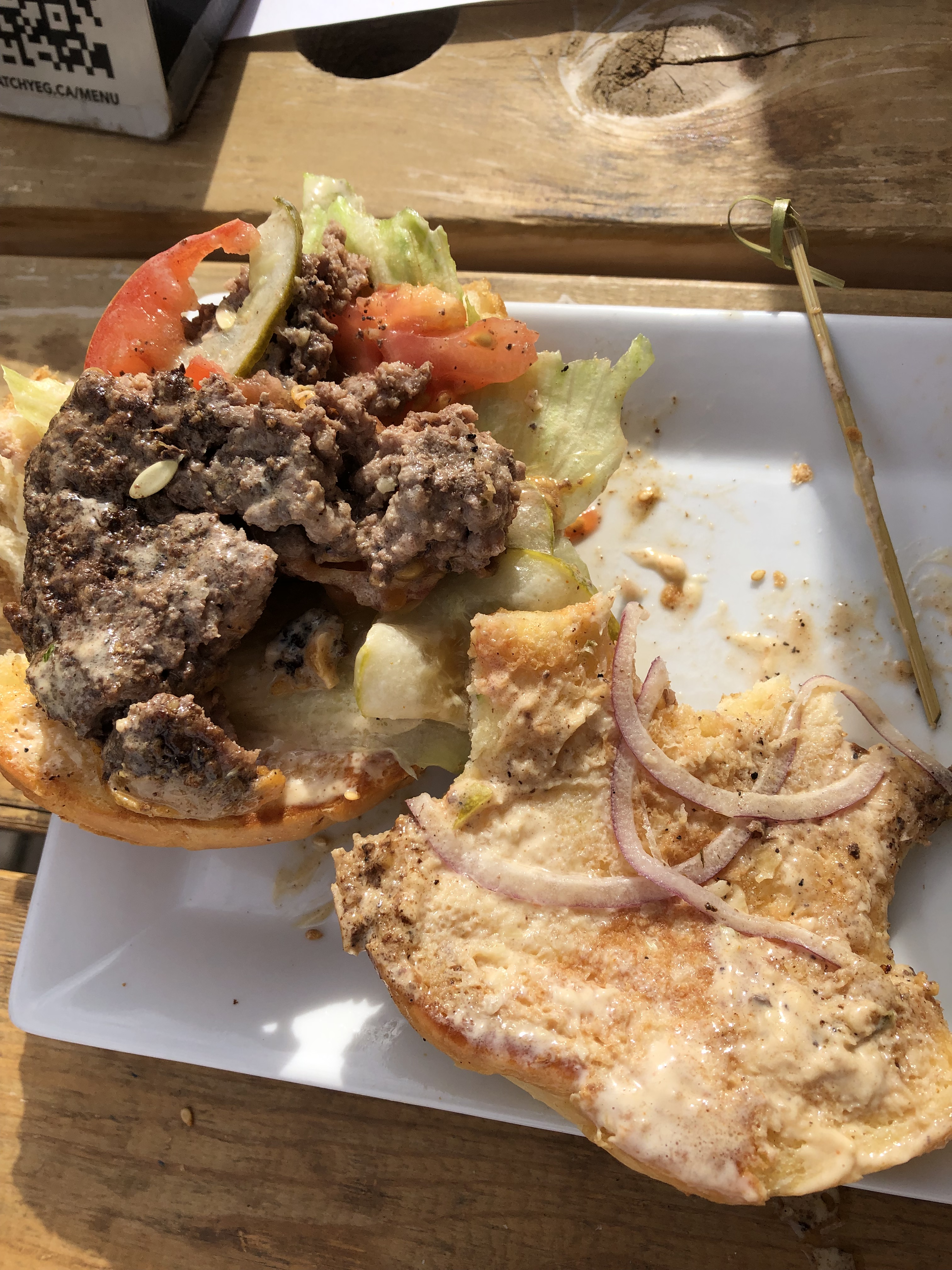 The interior of the burger, which appears very messy and is falling apart. 