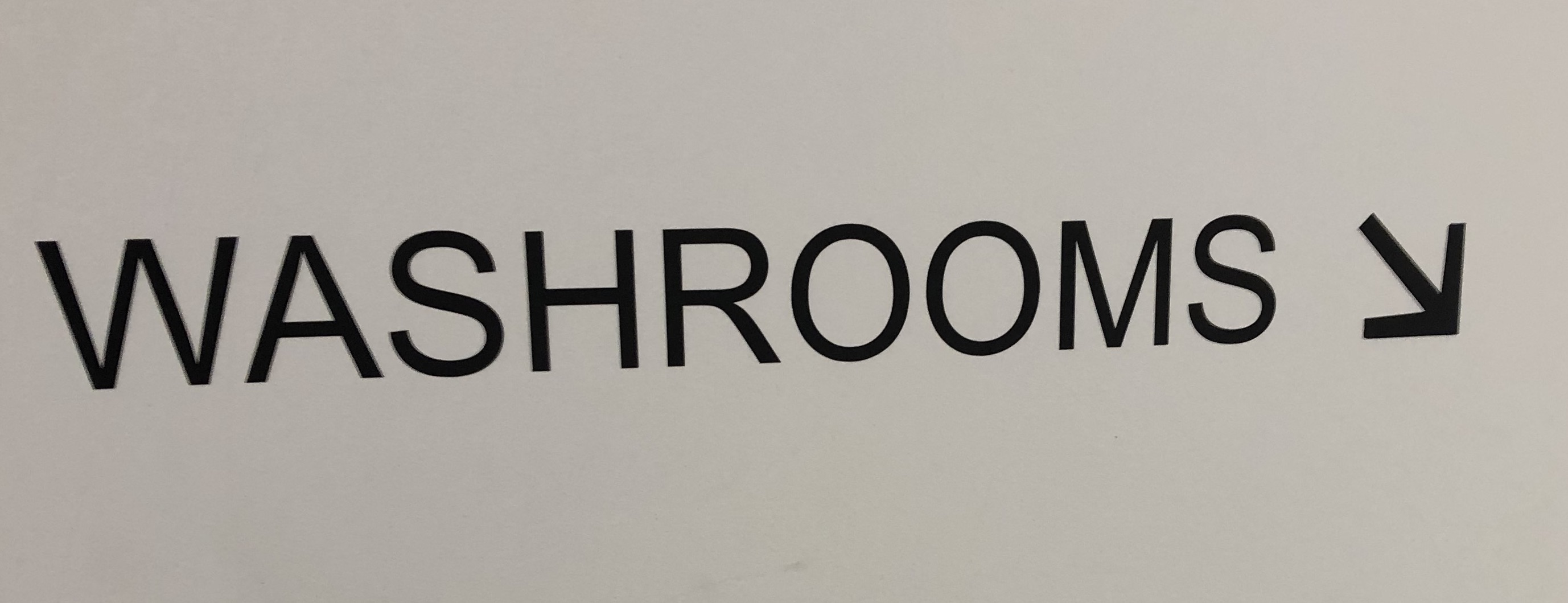 Washroom Sign with arrow pointing downward. 