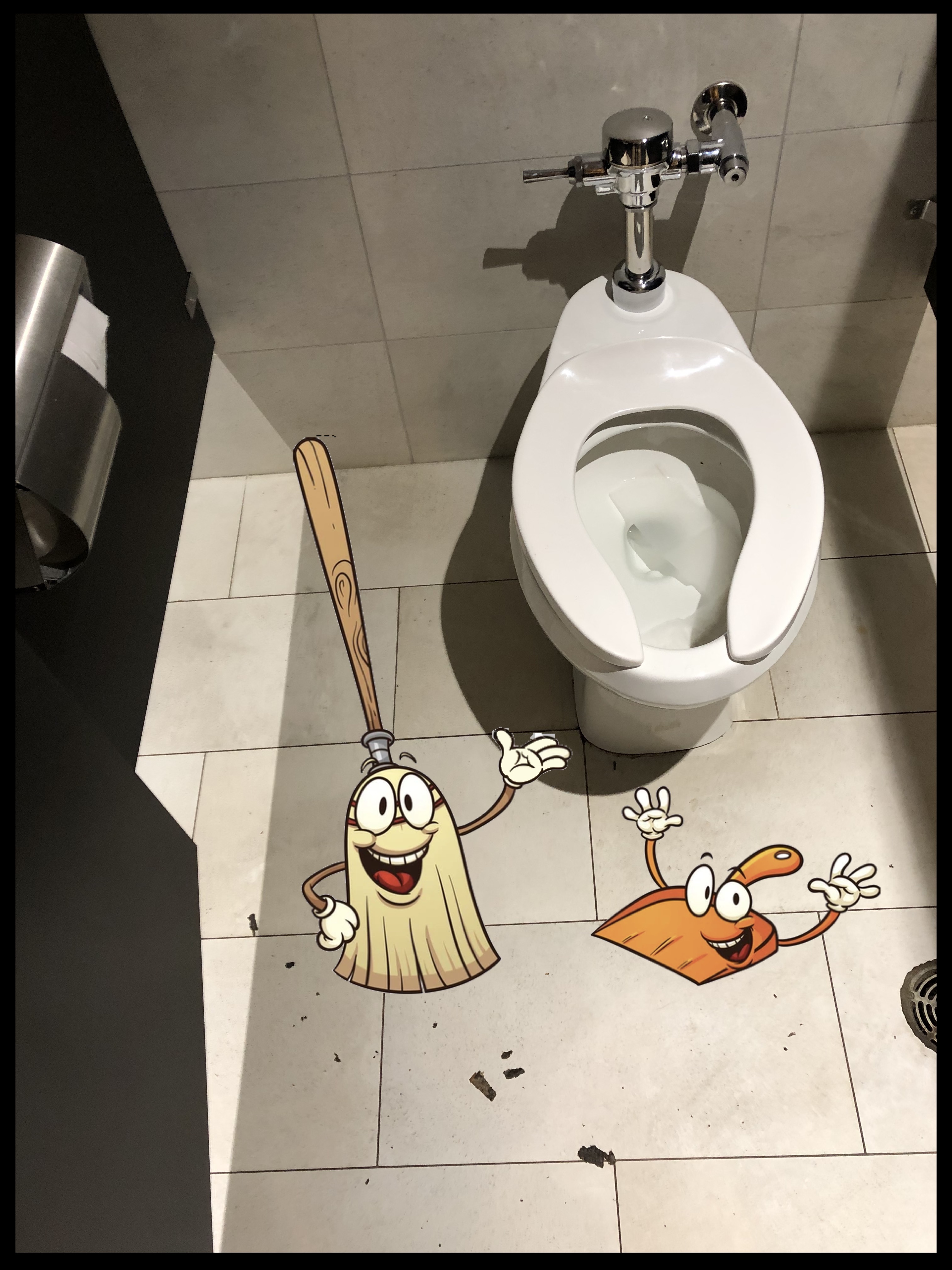 Some debris on the floor in the stall, with a smiling broom and dustpan happy to clean it up. 