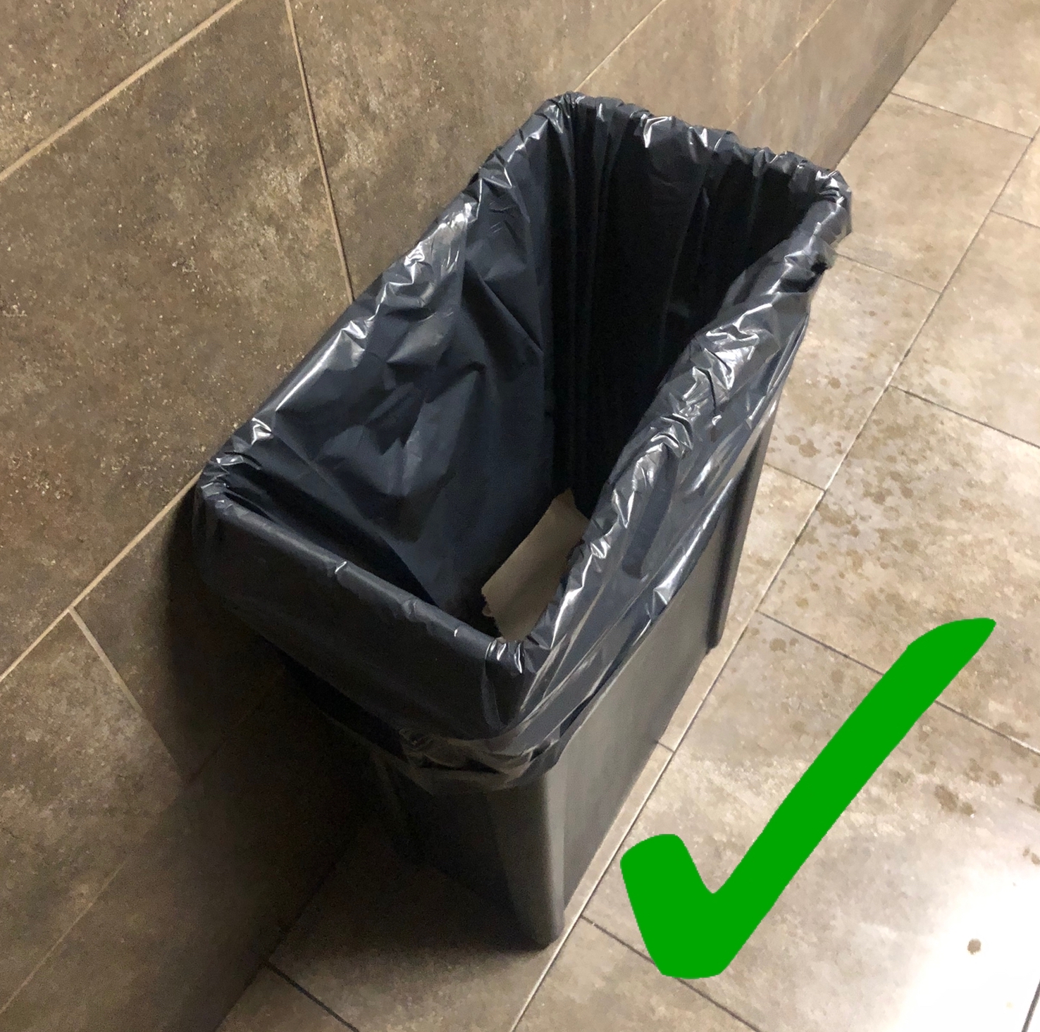 A garbage can with a green check mark. 
